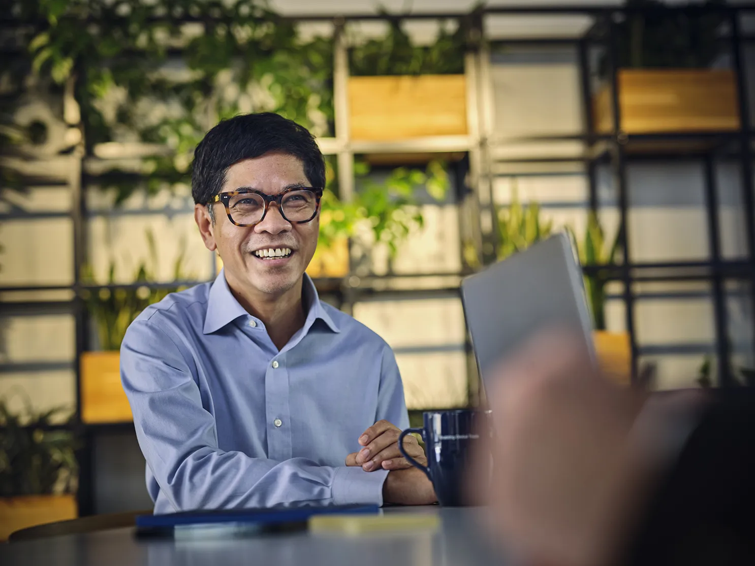 man in canteen discussing with a colleague