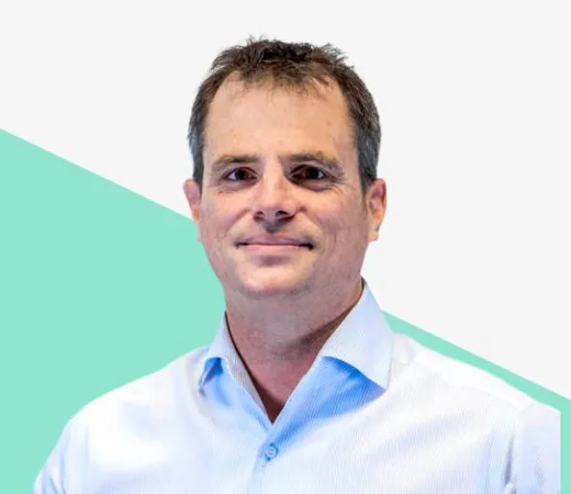 Man in a light blue shirt against a white background.