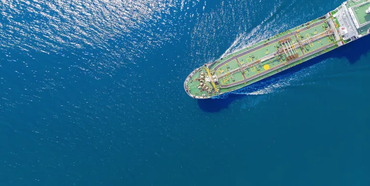 Aerial view of a ship on blue waters.