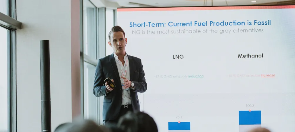 Presenter discusses fuel production with a chart.