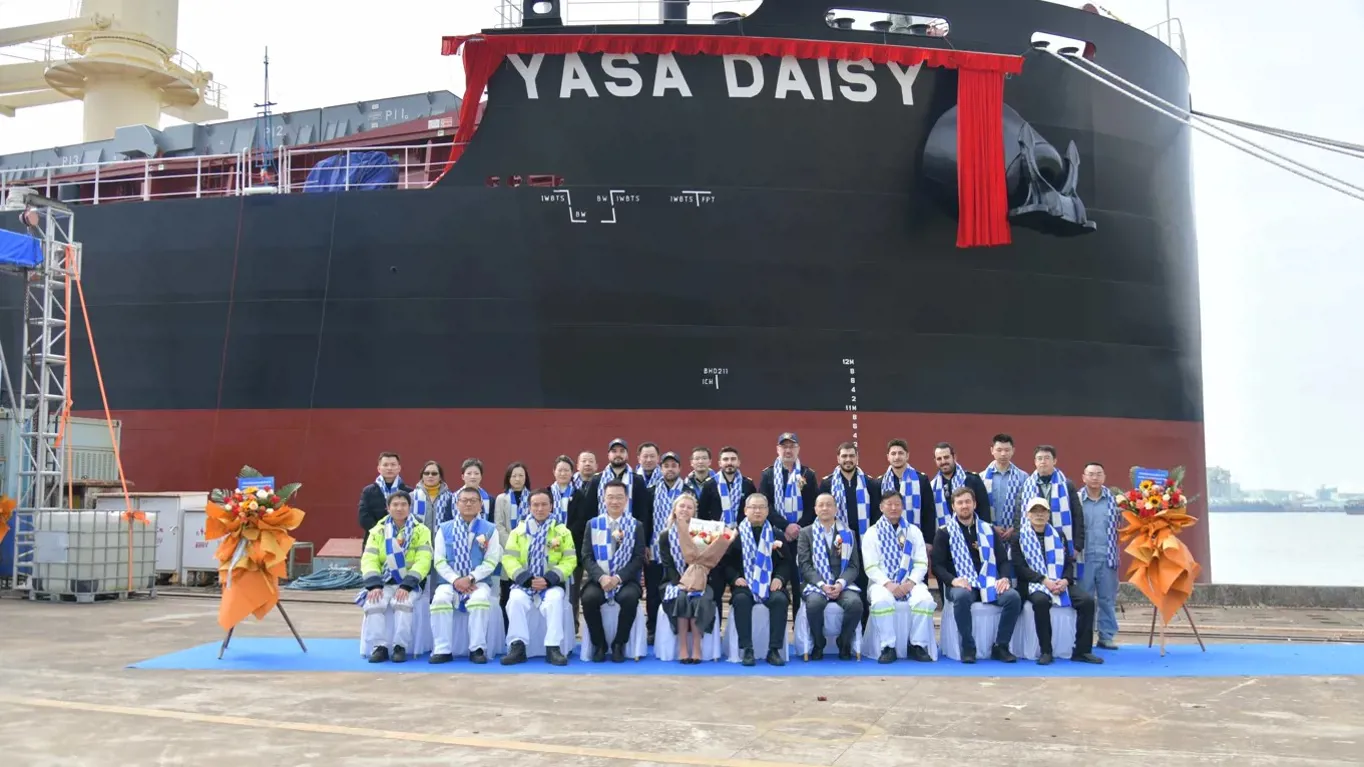 group of people sitting in front of a ship