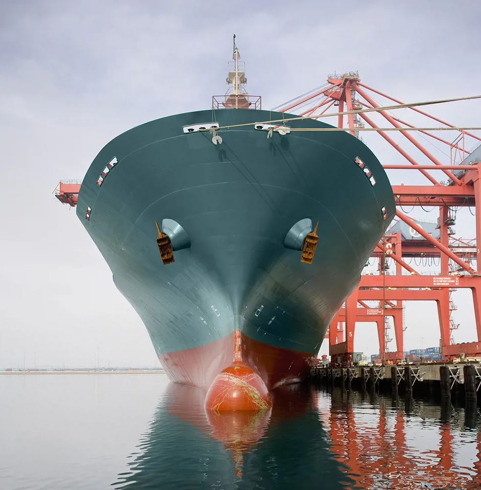 Bow of a red and teal cargo ship