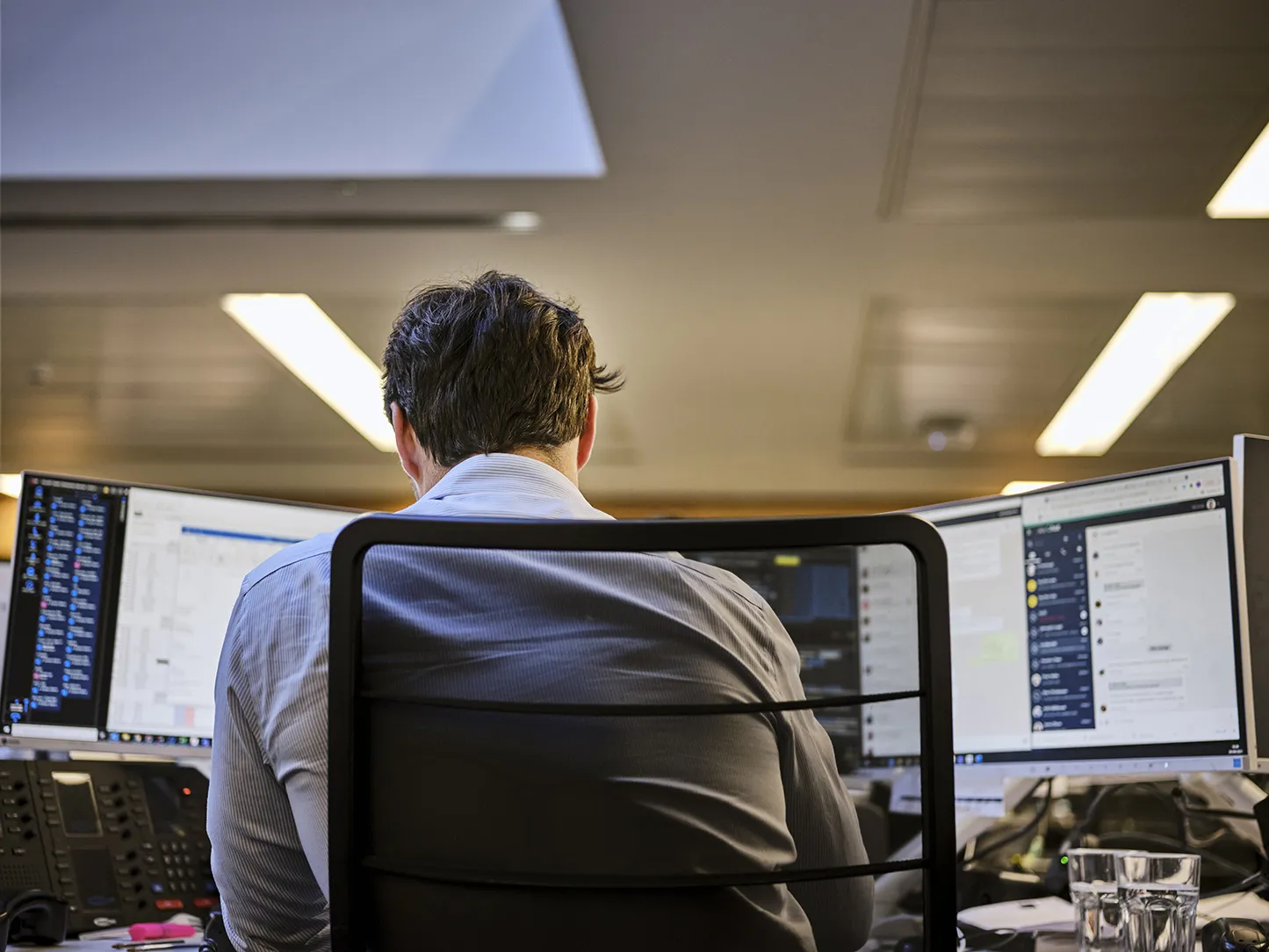 close up of a man looking at his computer screens