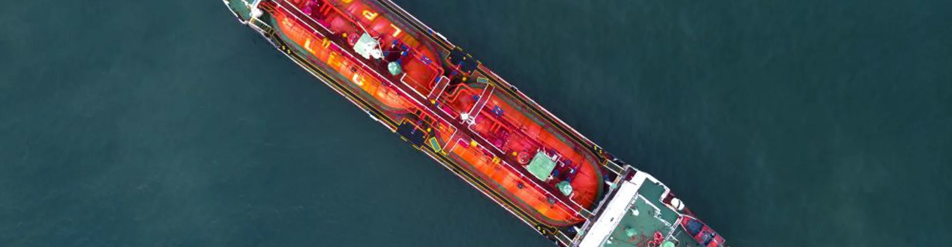 Aerial view of a large cargo ship on water.
